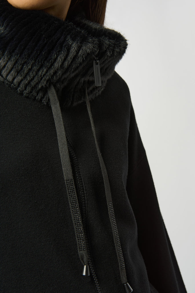 Close-up of fur-trimmed collar and rhinestone accents on knit coat