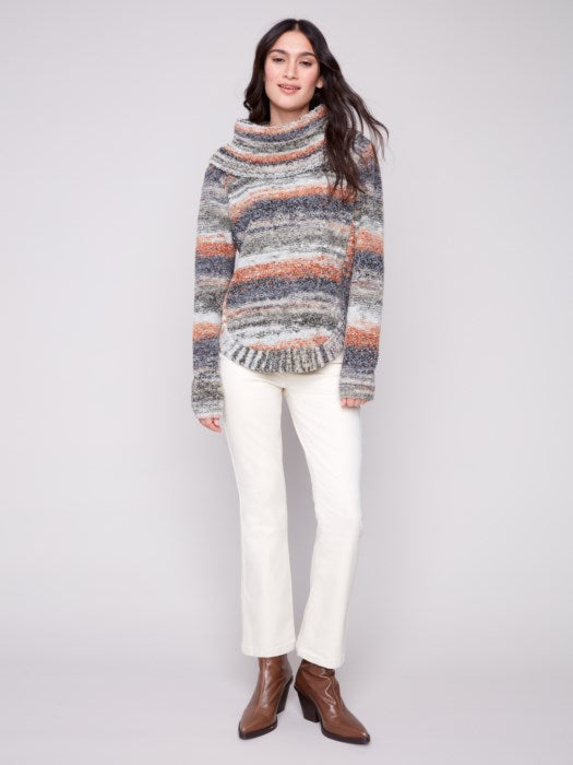 Model wearing fall-ready ombré sweater with boots and jeans