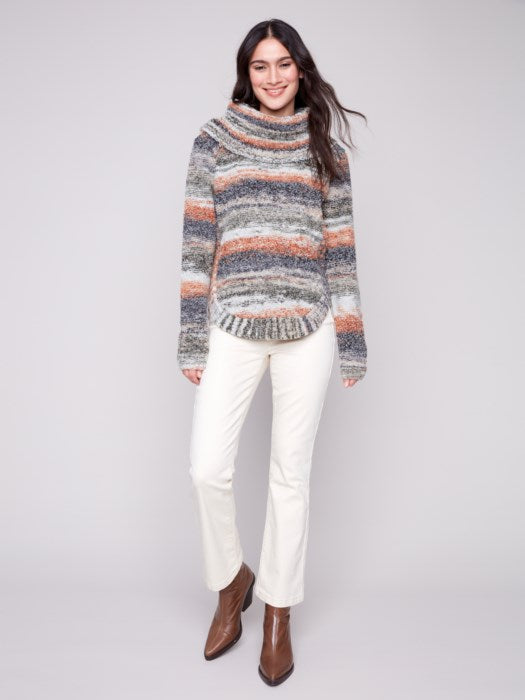 Model wearing fall-ready ombré sweater with boots and jeans
