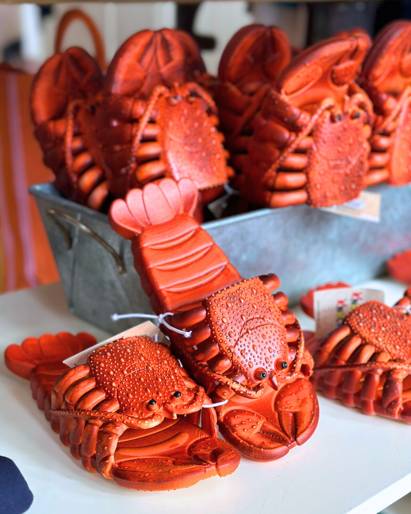 Bright red lobster-shaped sandals displayed in-store