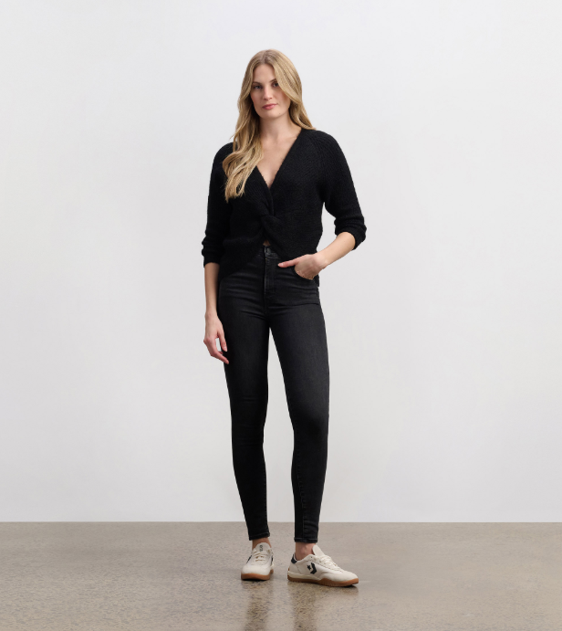 Model wearing Hatley Cross Over Sweater with jeans for a casual fall look