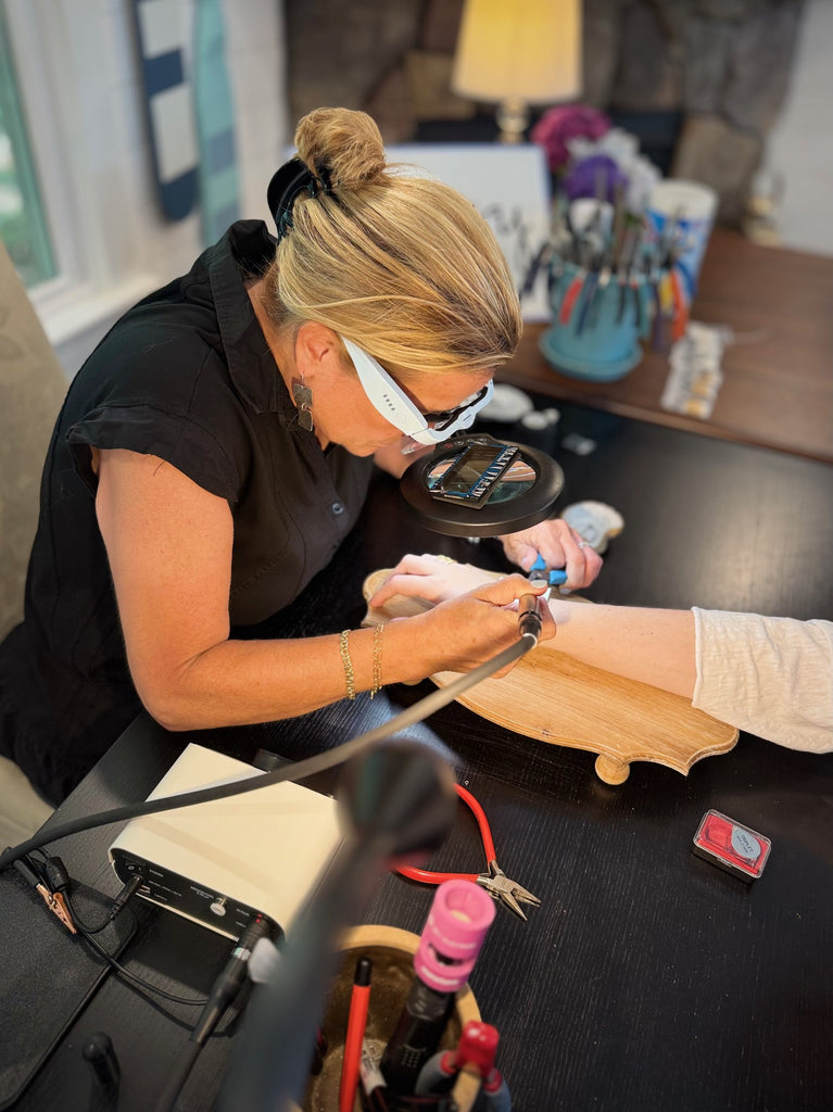Local jeweler Lisa Labonte Myers welding a custom-fit bracelet