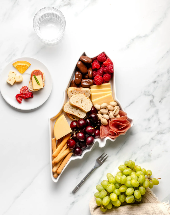 Overhead view of Maine-shaped plate filled with a charcuterie fixings