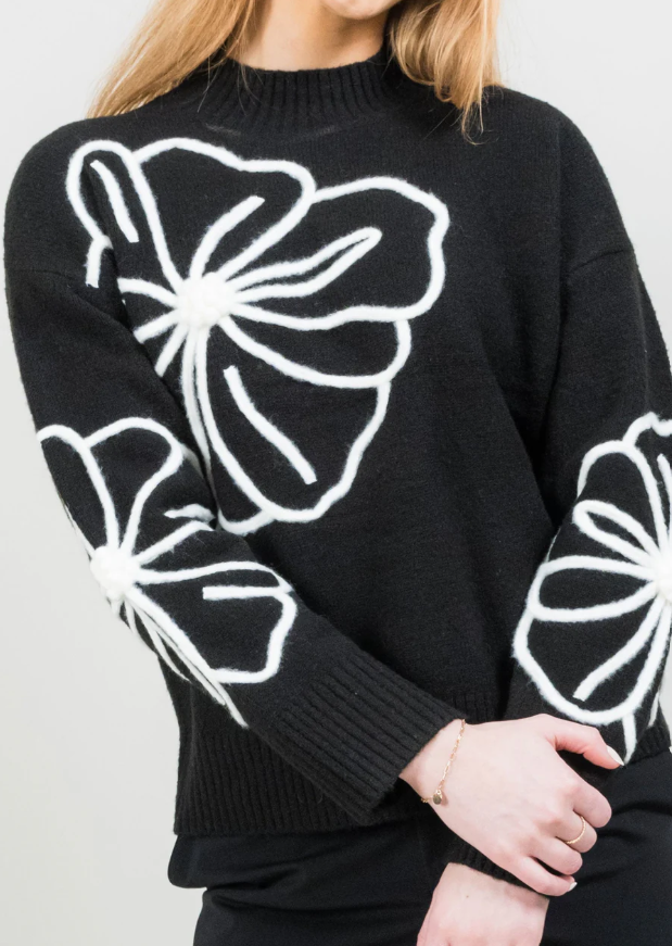 Close-up of poppy embroidery on Lisette mockneck knit top
