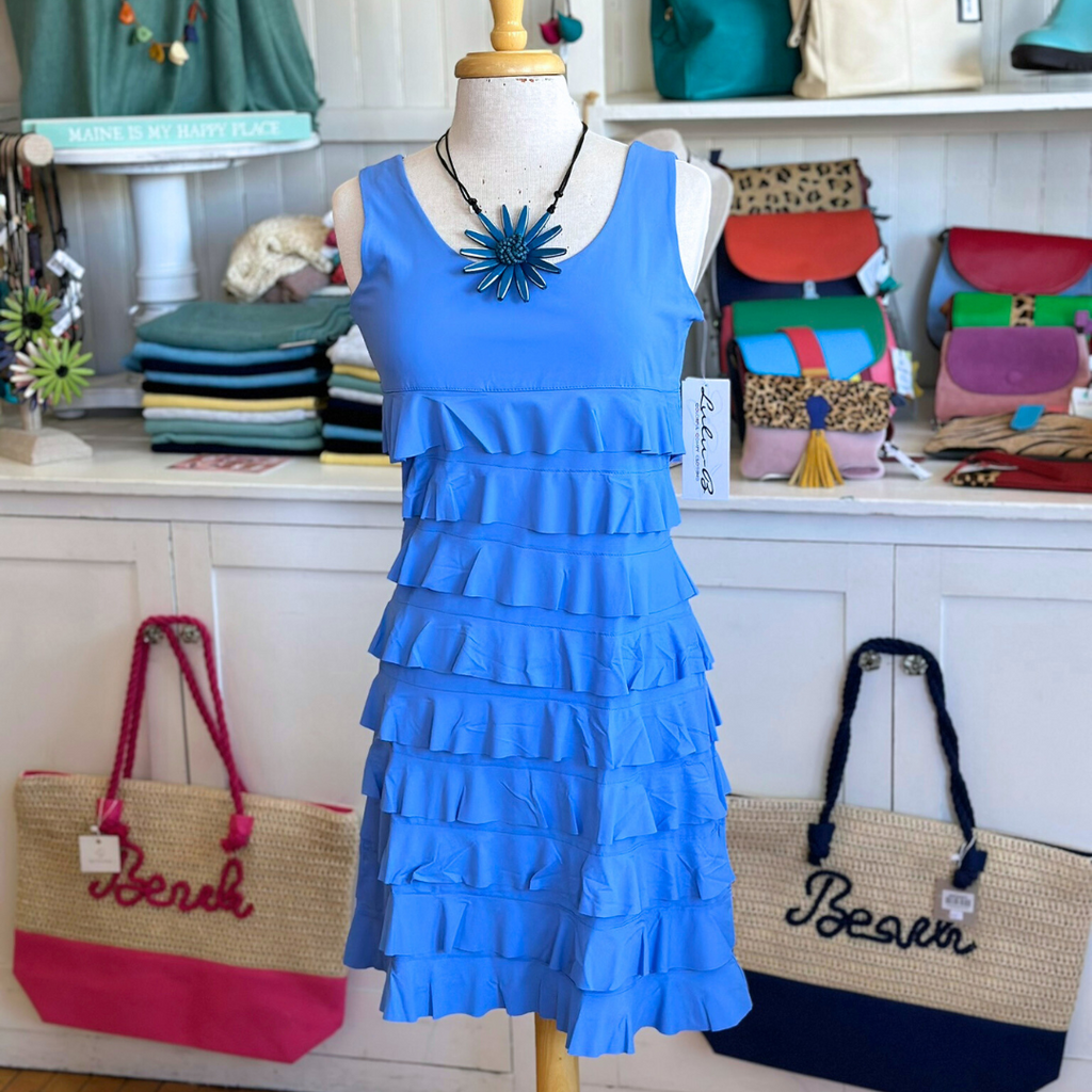 Woman wearing Lulu-B Sleeveless Cha Cha Dress featuring bold patterns, layered Cha Cha design, and UPF 50+ sun protection, perfect for spring and summer outings.​
