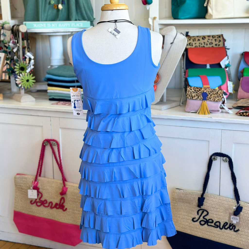 Woman wearing Lulu-B Sleeveless Cha Cha Dress featuring bold patterns, layered Cha Cha design, and UPF 50+ sun protection, perfect for spring and summer outings.​
