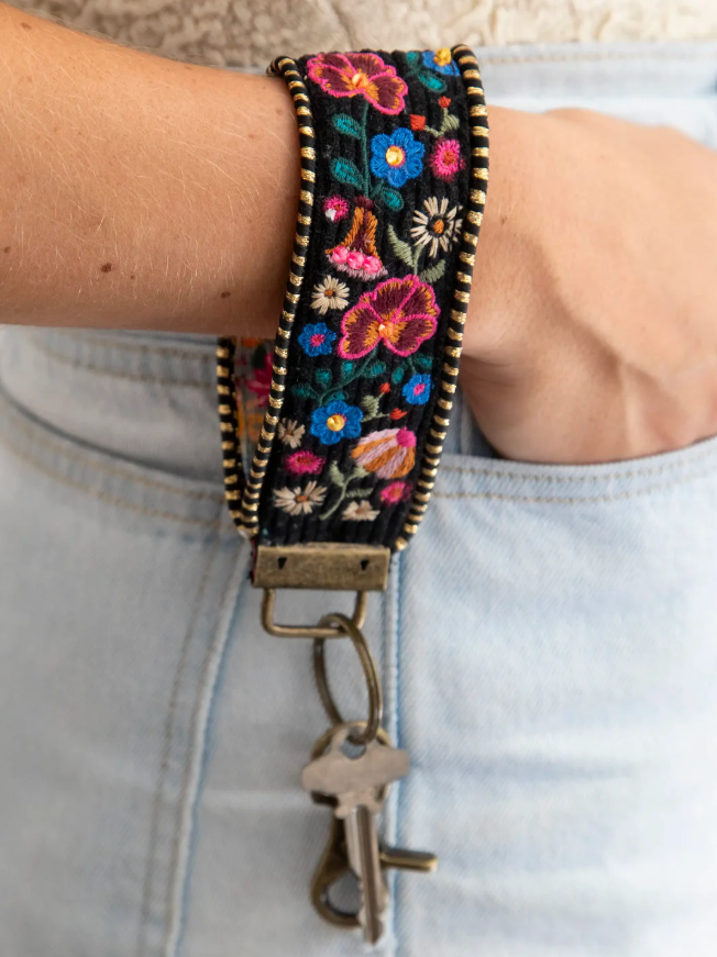 Natural Life key chain inspired by global travel with embroidered trim