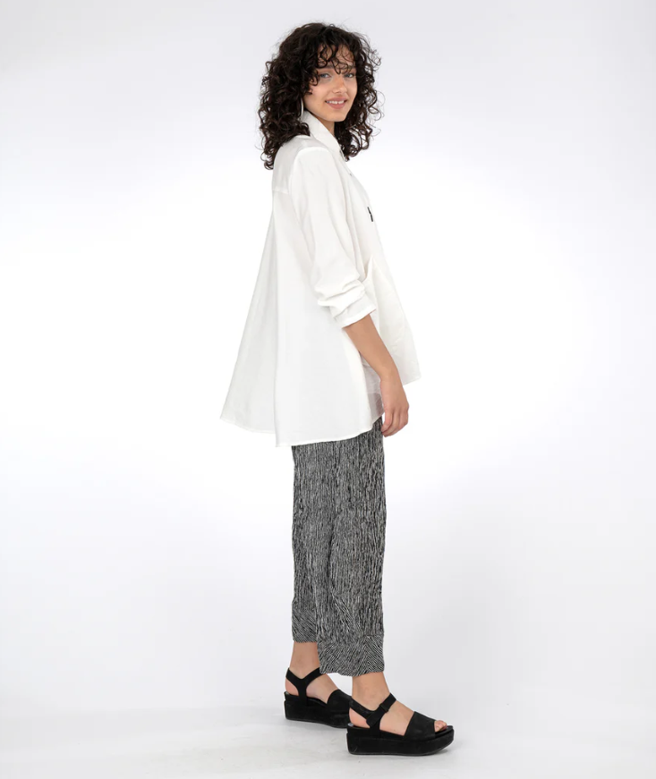 Side view of Flowy Blouse with lowered back hem