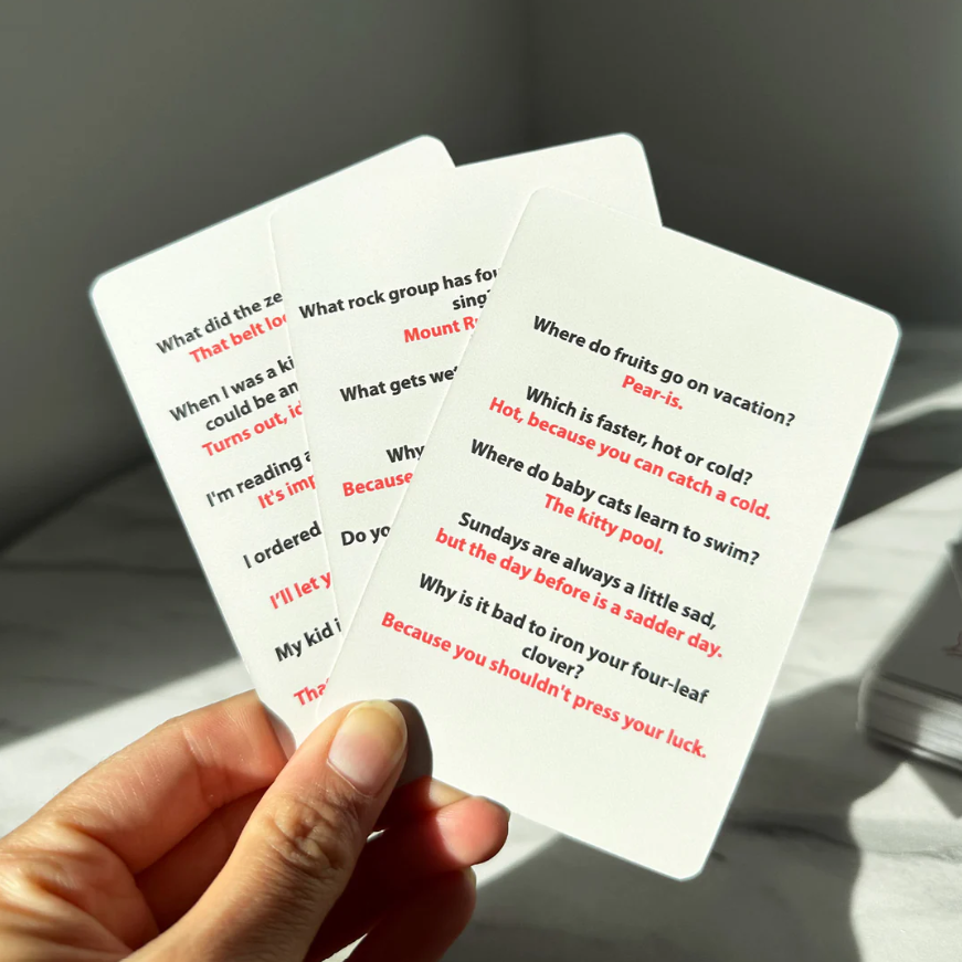 Dad Jokes Cards box held in hand, ready to gift