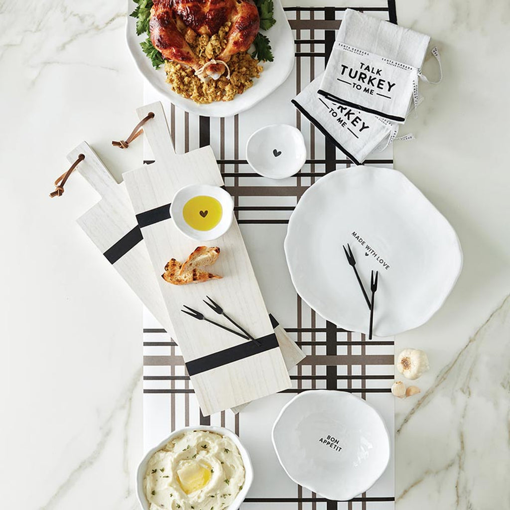 Bowl holding dip on a charcuterie board