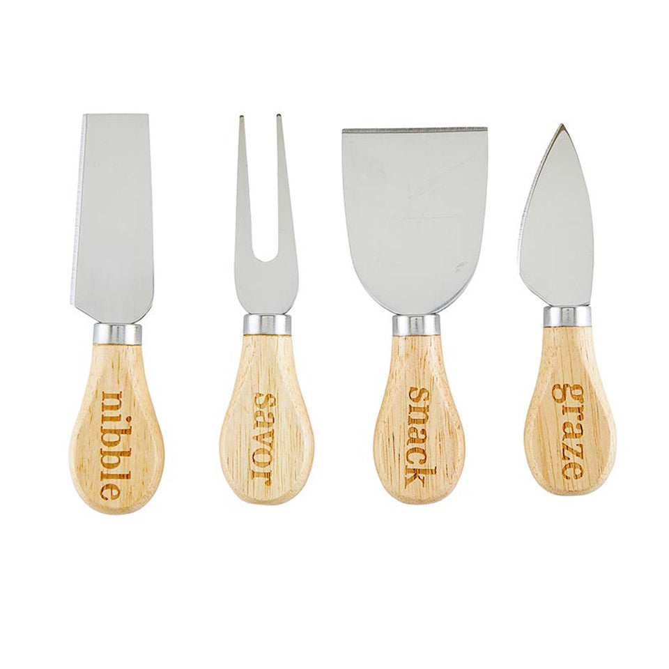 Cheese knives laid out with carved handles featuring the words: nibble, savor, snack, and graze