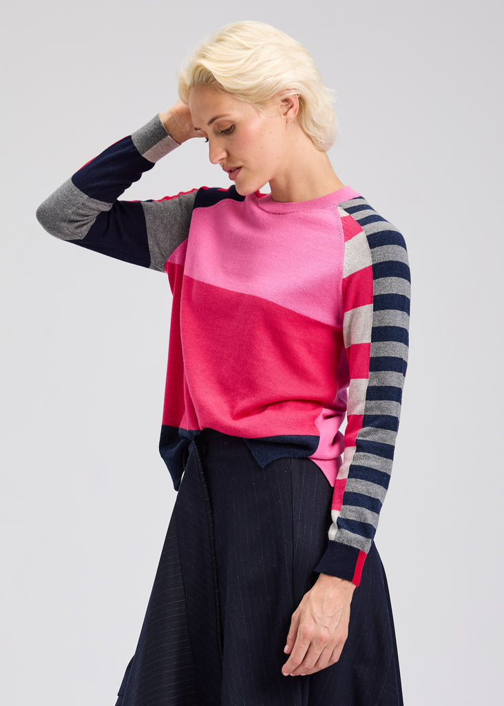 Side view of colorful striped sweater styled with denim